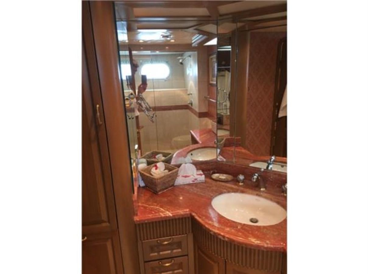 a bathroom with a sink and a mirror aboard MCY Yacht for Sale