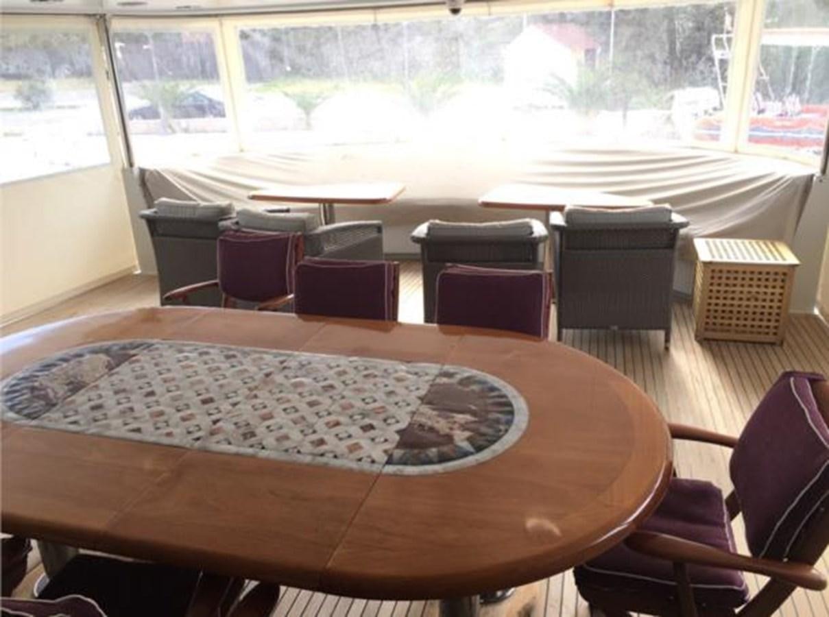 a room with a table and chairs aboard MCY Yacht for Sale