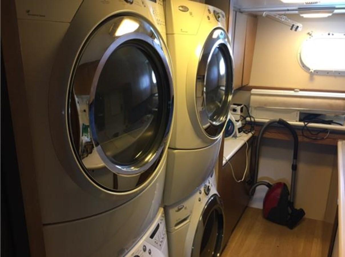 a white machine with a round black object on the side aboard MCY Yacht for Sale