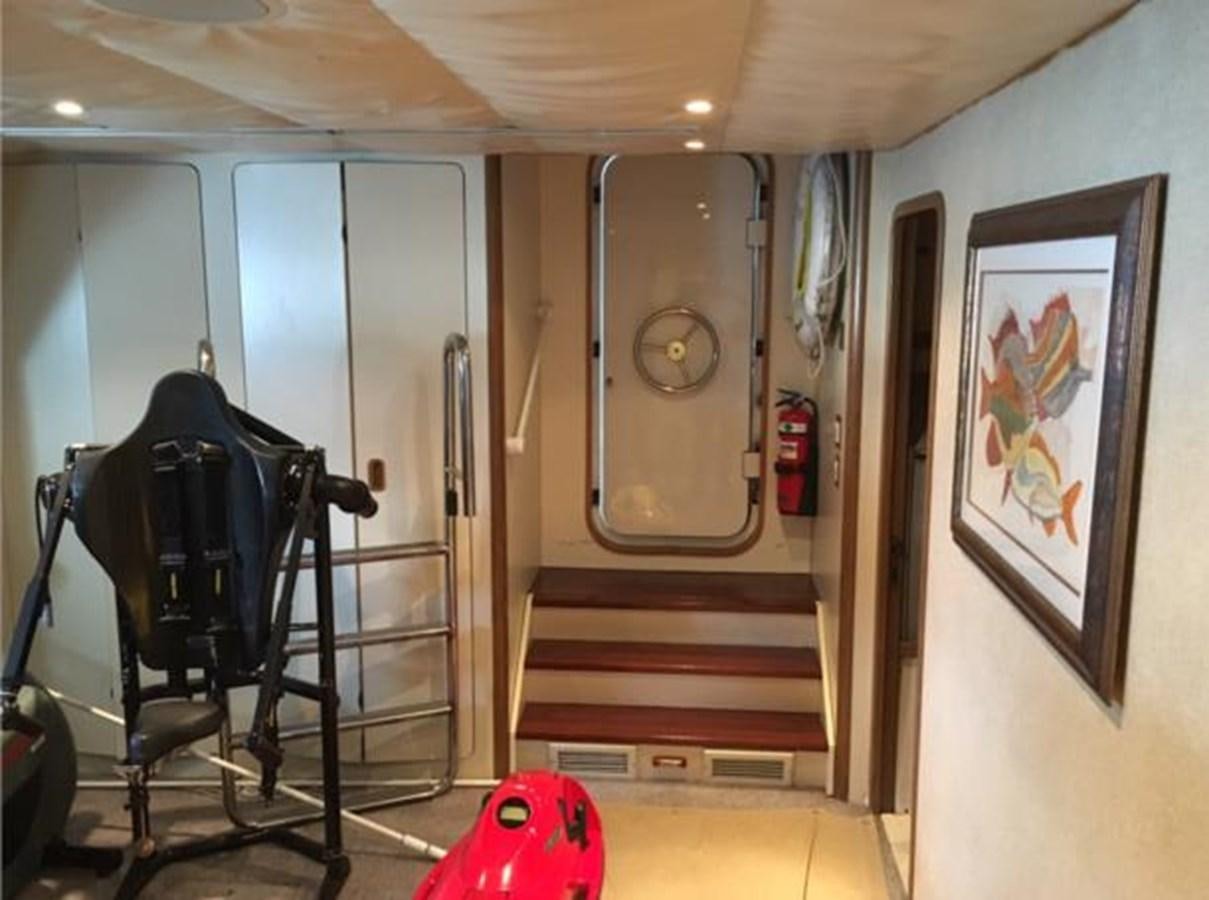 a room with a chair and a desk aboard MCY Yacht for Sale
