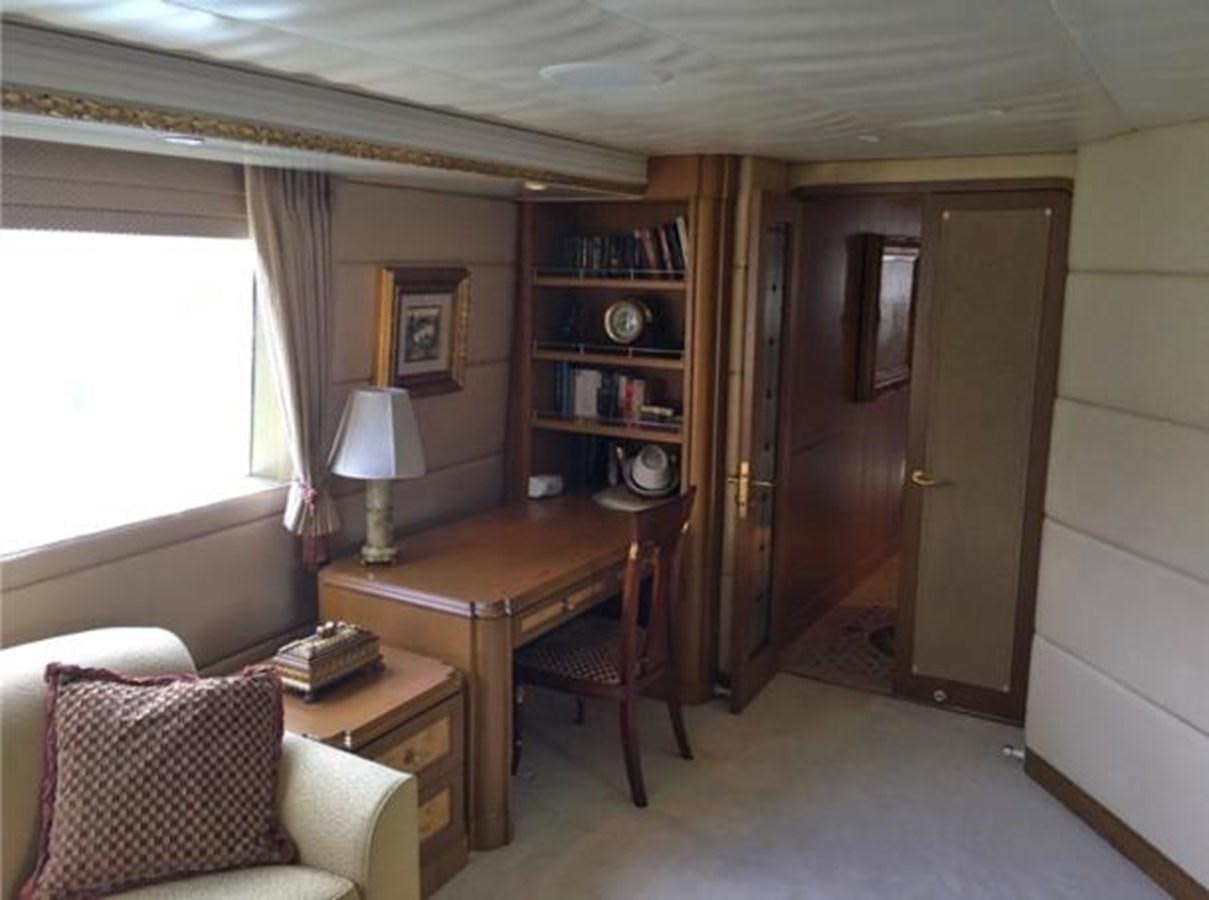 a room with a table and a couch aboard MCY Yacht for Sale