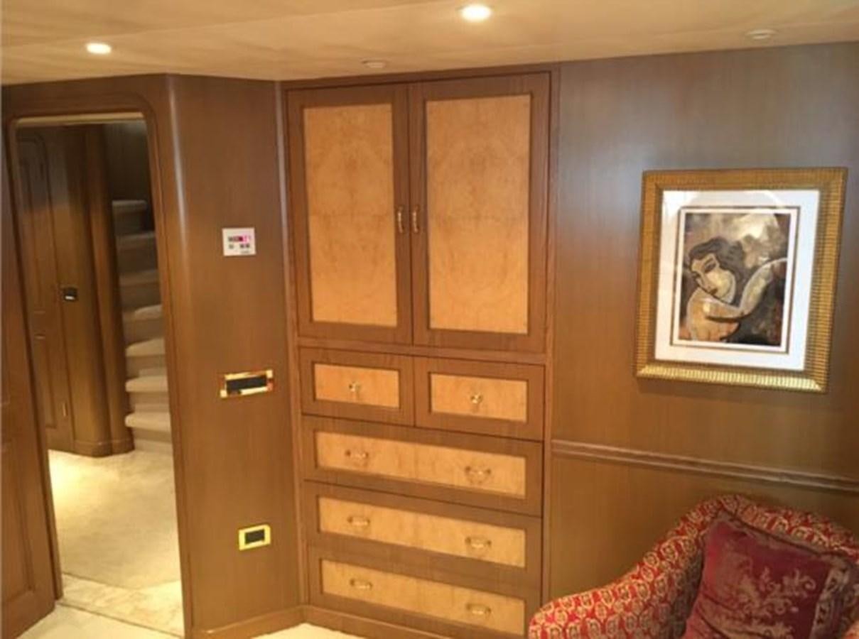 a room with wooden cabinets aboard MCY Yacht for Sale