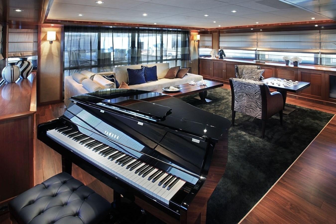a large living room with a piano aboard BEHIKE Yacht for Sale