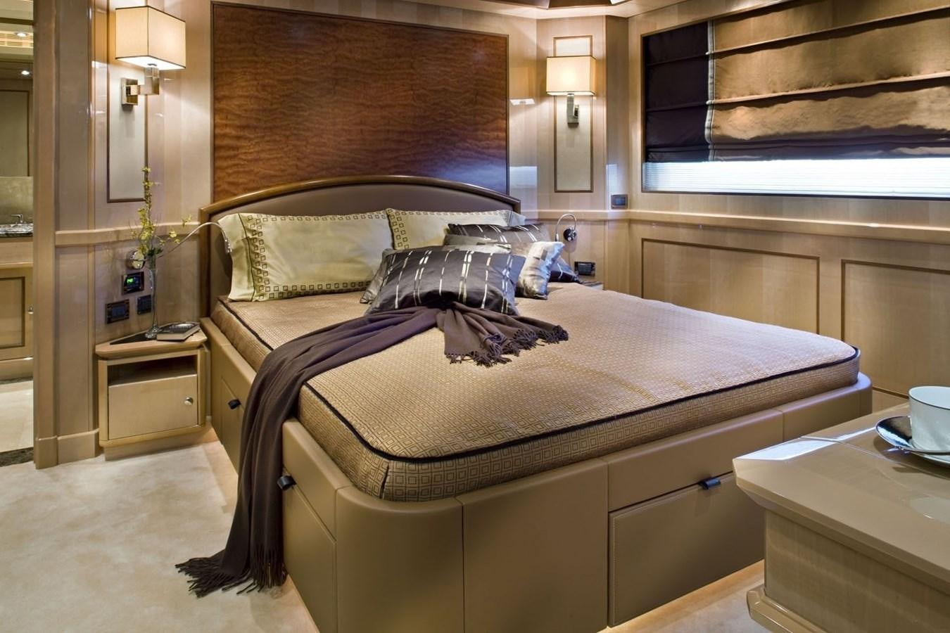 a bed with a white sheet and pillows on it aboard BEHIKE Yacht for Sale