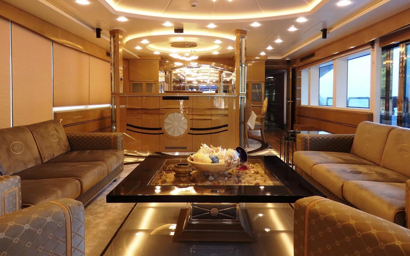 a living room with a table and couches aboard DESTINY Yacht for Sale