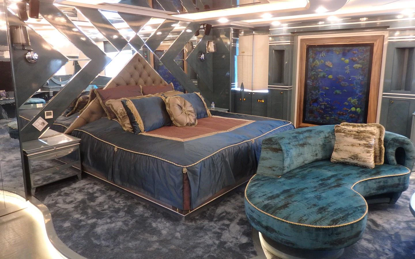 a bed and couch in a room aboard DESTINY Yacht for Sale