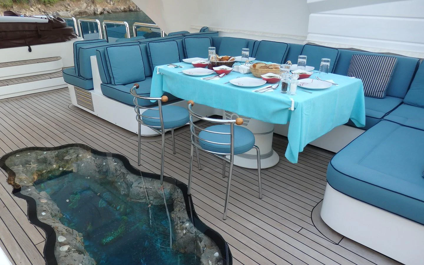 a pool with a table and chairs aboard DESTINY Yacht for Sale