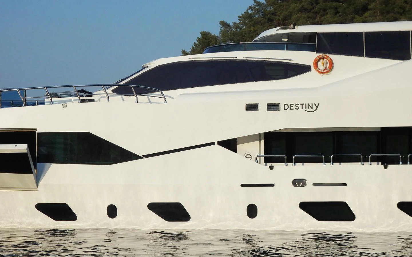 a white yacht on the beach aboard DESTINY Yacht for Sale