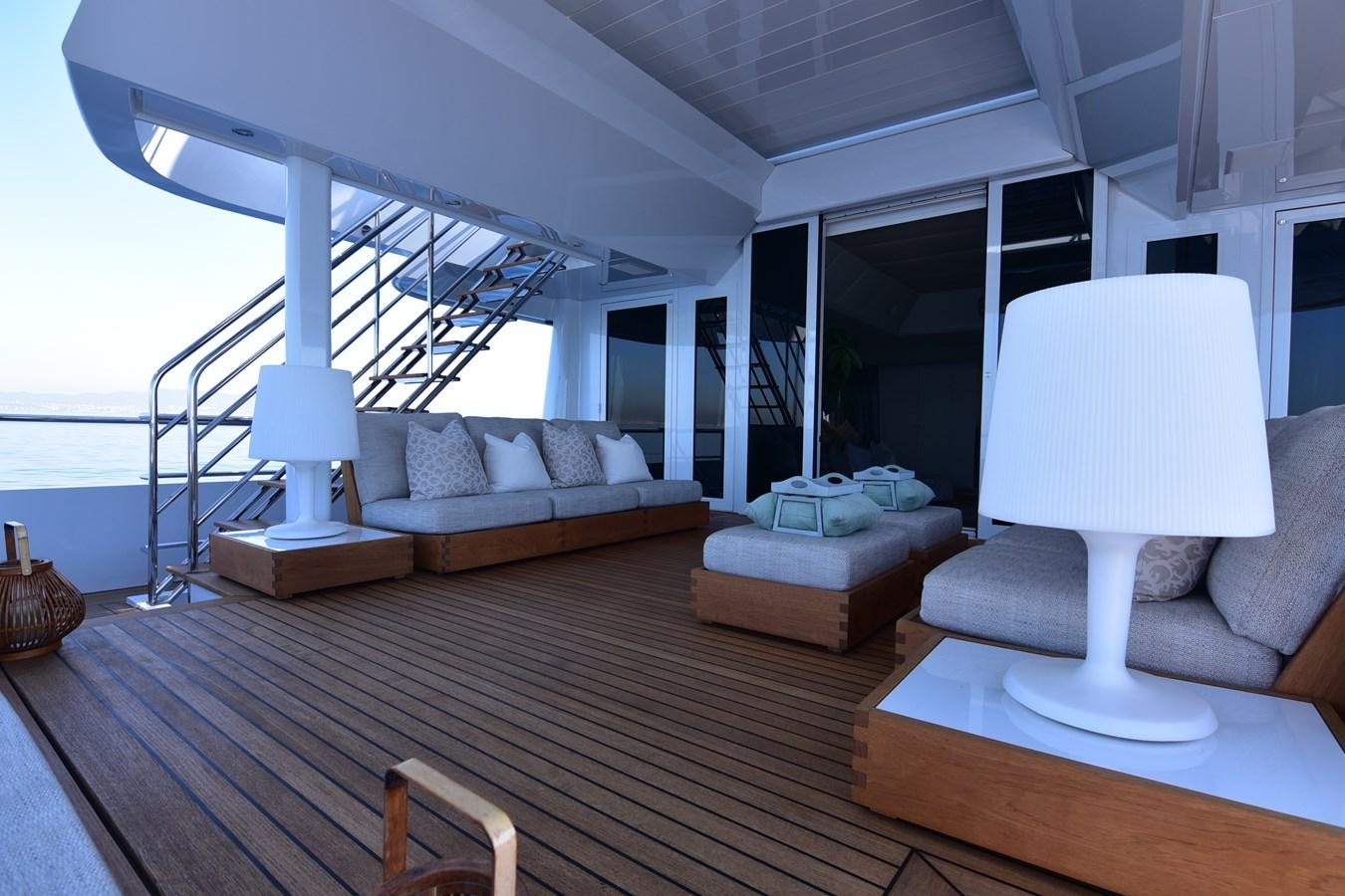 a living room with a large white lamp and a wood floor aboard LIFE SAGA Yacht for Sale
