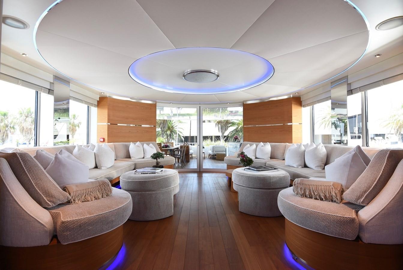 a living room with a large chandelier aboard LIFE SAGA Yacht for Sale