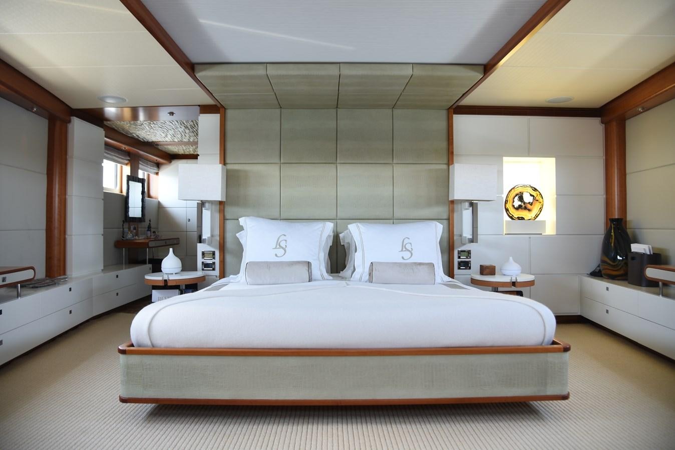a bed with a white comforter aboard LIFE SAGA Yacht for Sale