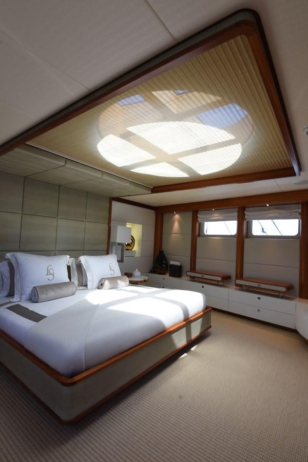 a room with a bed and a ceiling fan aboard LIFE SAGA Yacht for Sale