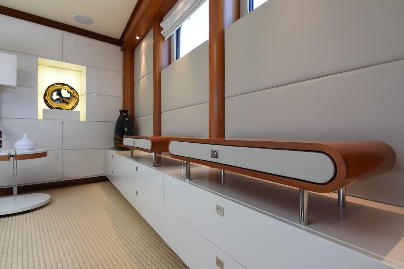 a room with a bench and a table aboard LIFE SAGA Yacht for Sale