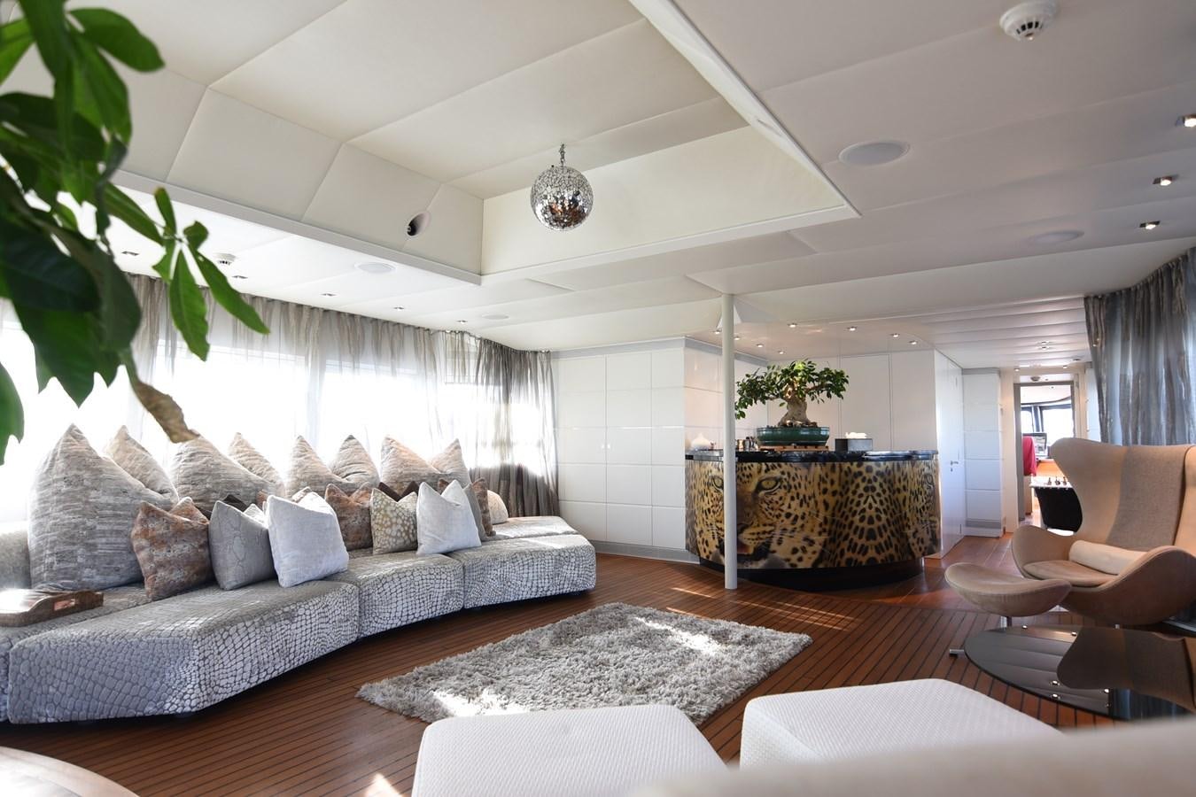 a living room with a large sofa aboard LIFE SAGA Yacht for Sale