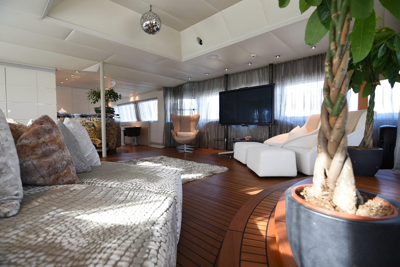 a living room with a large fireplace aboard LIFE SAGA Yacht for Sale