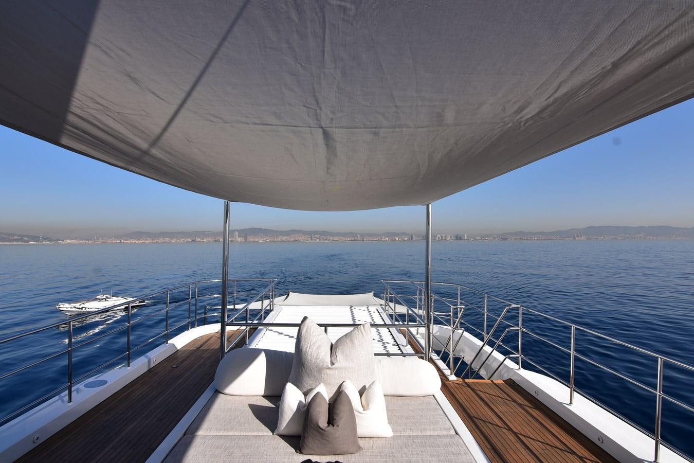 a deck with chairs on it by the water aboard LIFE SAGA Yacht for Sale