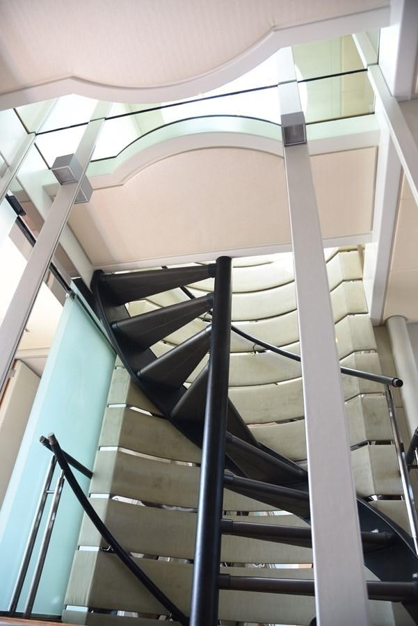 a staircase with glass walls aboard LIFE SAGA Yacht for Sale