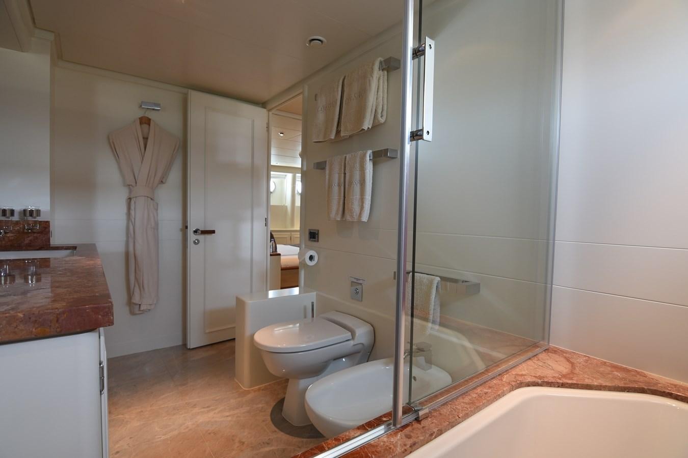a bathroom with a bathtub and toilet aboard LIFE SAGA Yacht for Sale