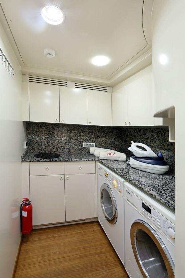 a kitchen with white cabinets aboard DAIMA Yacht for Sale
