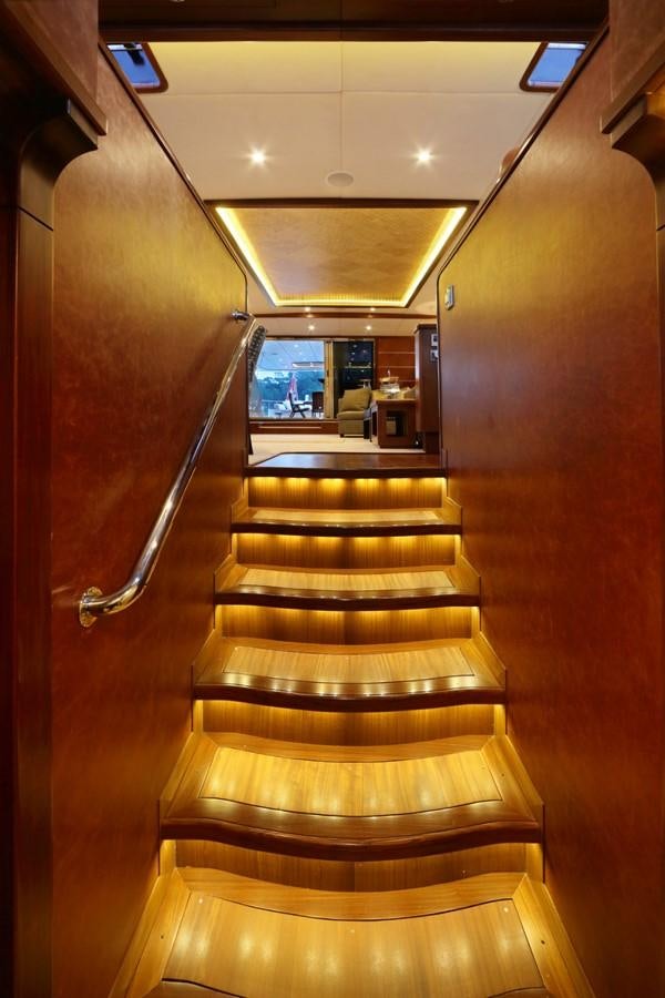 a wooden staircase in a building aboard DAIMA Yacht for Sale
