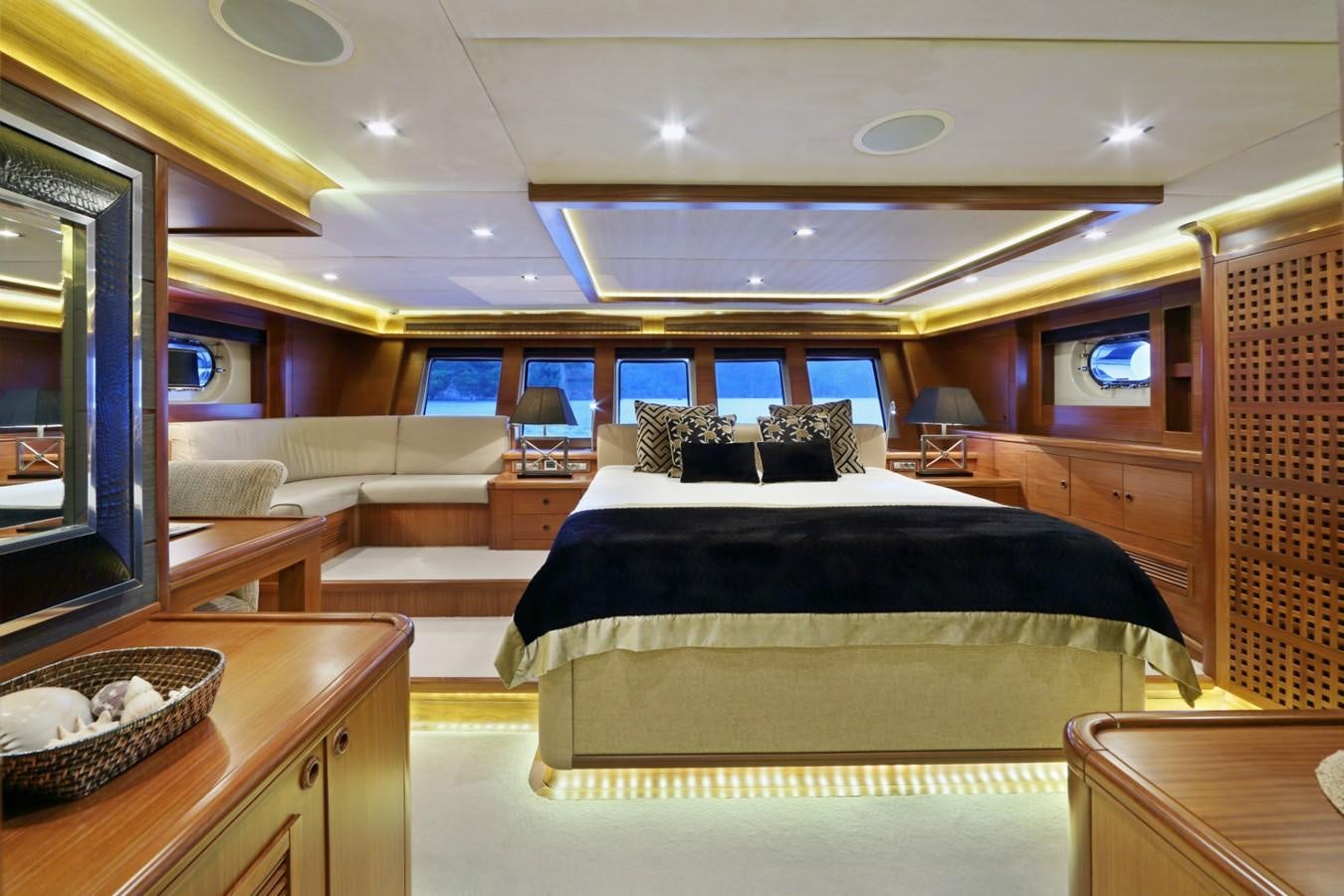 a room with a bed and a table aboard DAIMA Yacht for Sale