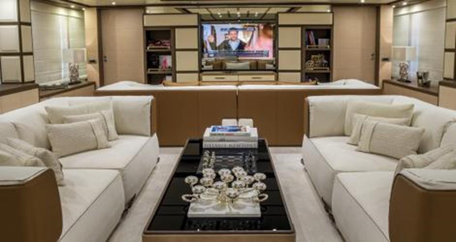 a living room with a large television aboard NELA Yacht for Charter