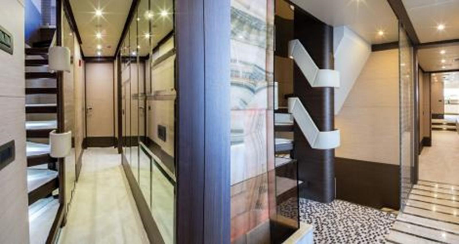 a hallway with a glass door aboard NELA Yacht for Sale