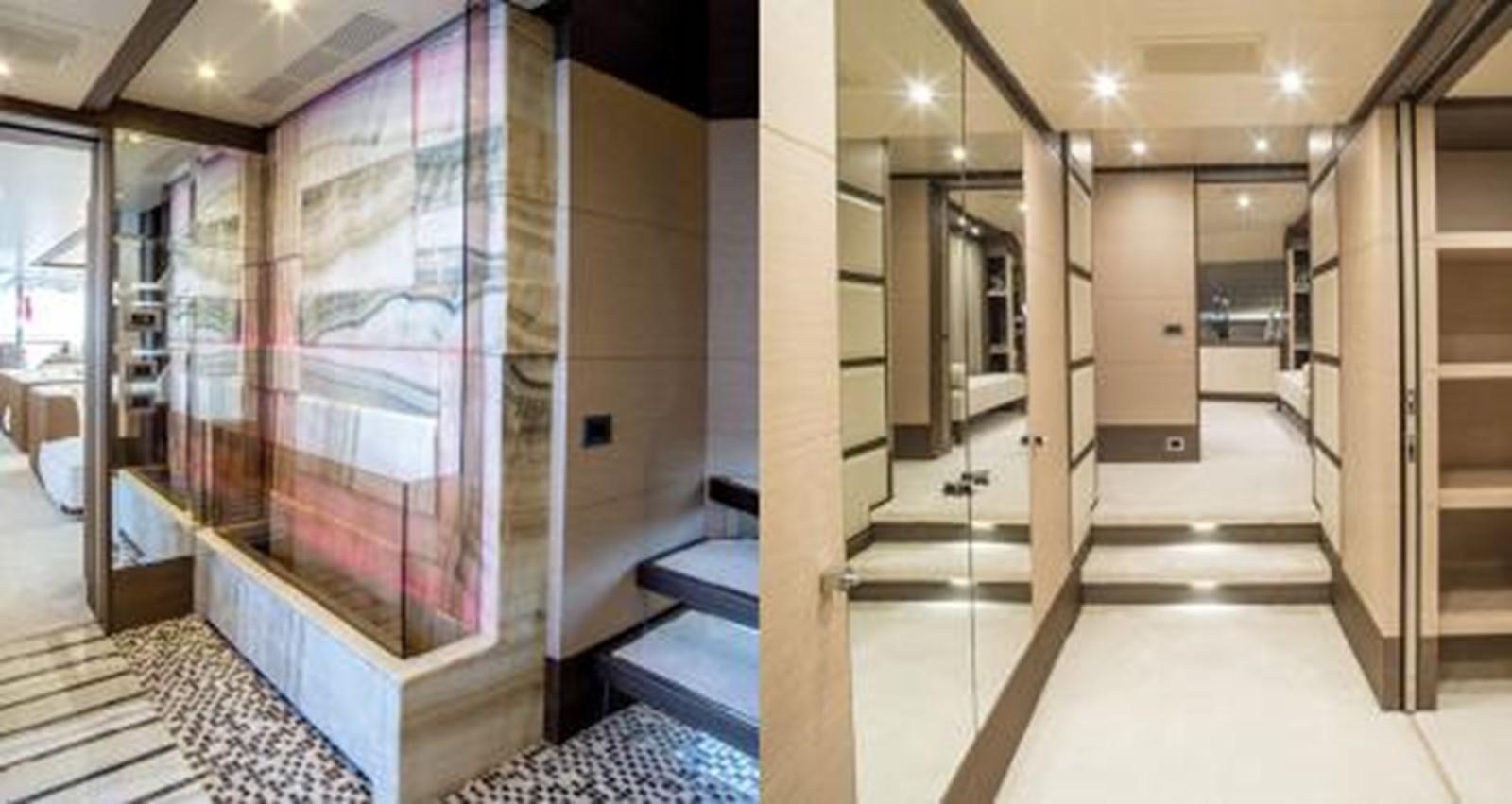 a hallway with glass doors aboard NELA Yacht for Sale