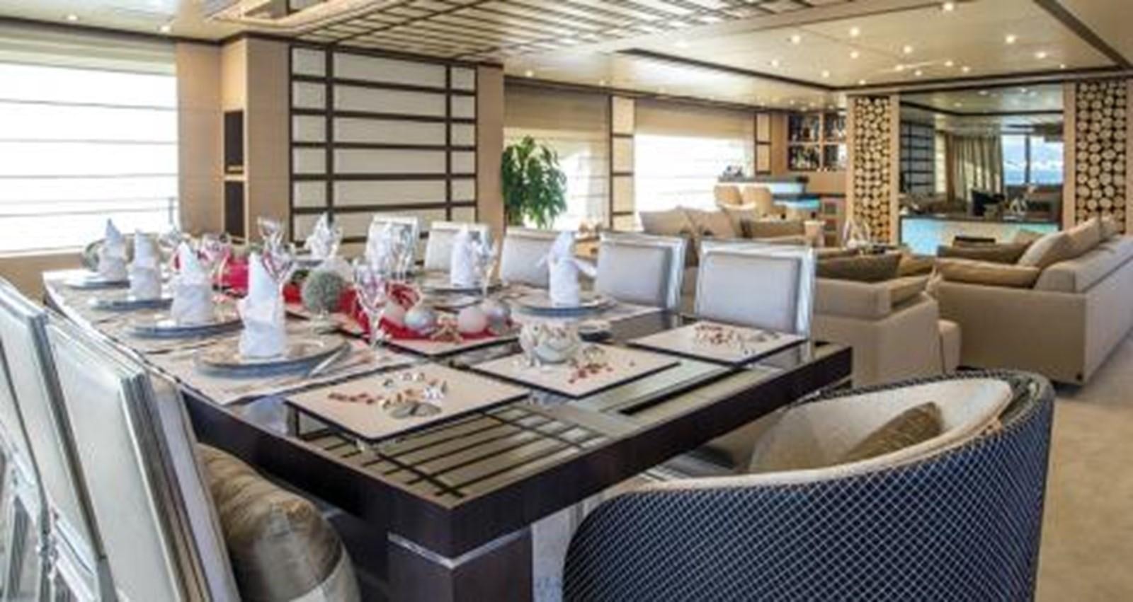 a large room with a table and chairs aboard NELA Yacht for Sale
