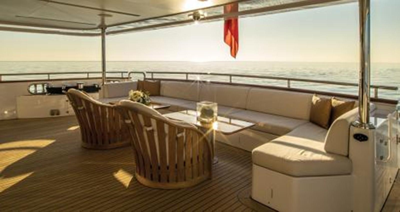 a room with a couch and chairs aboard NELA Yacht for Sale