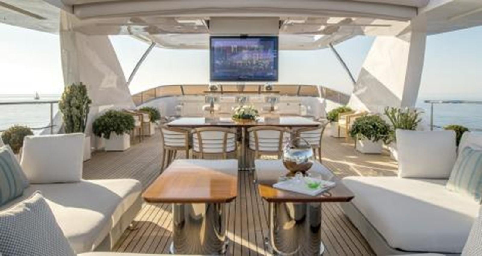 a room with a table and chairs aboard NELA Yacht for Sale