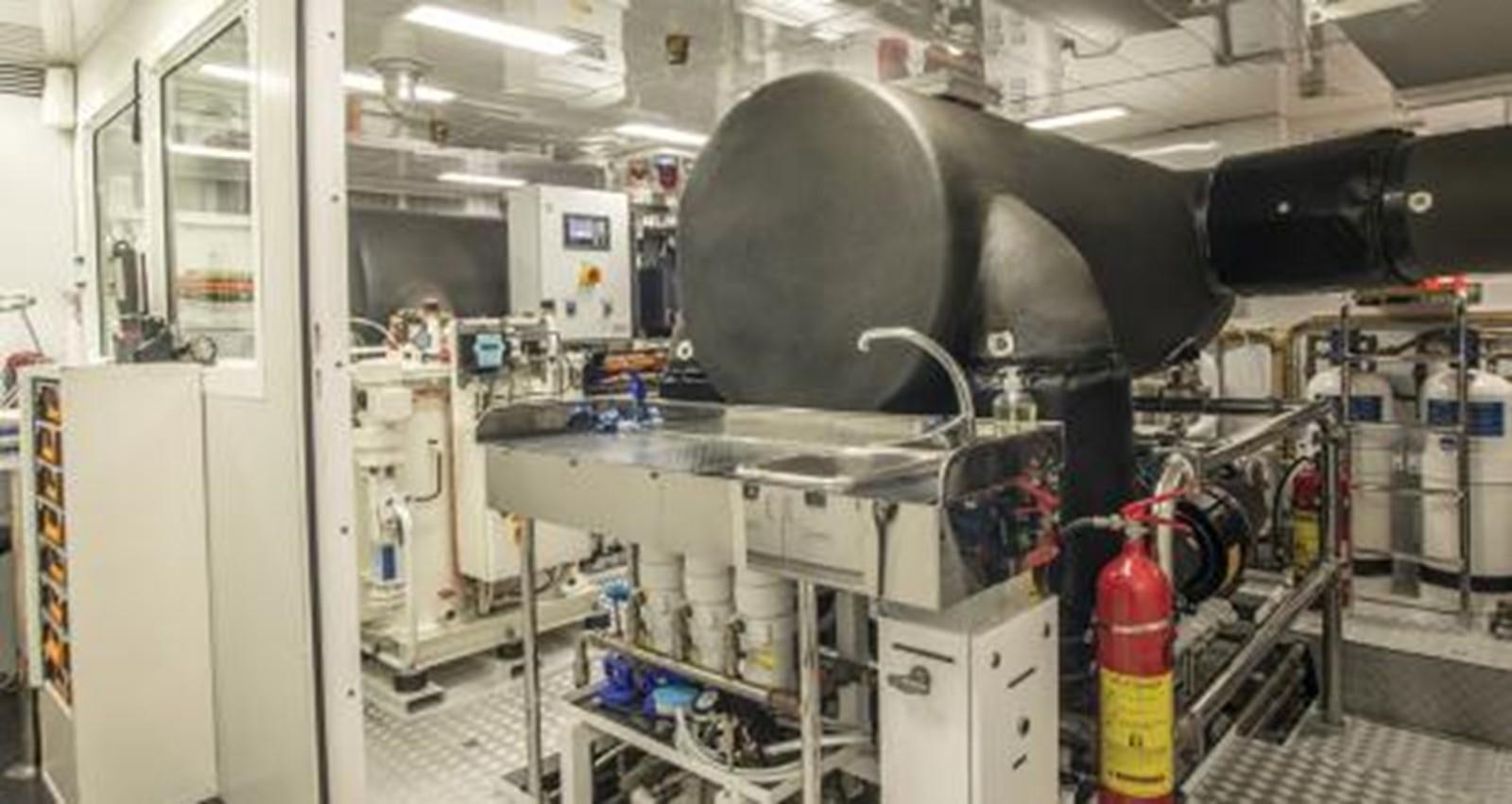a large machine in a room aboard NELA Yacht for Sale