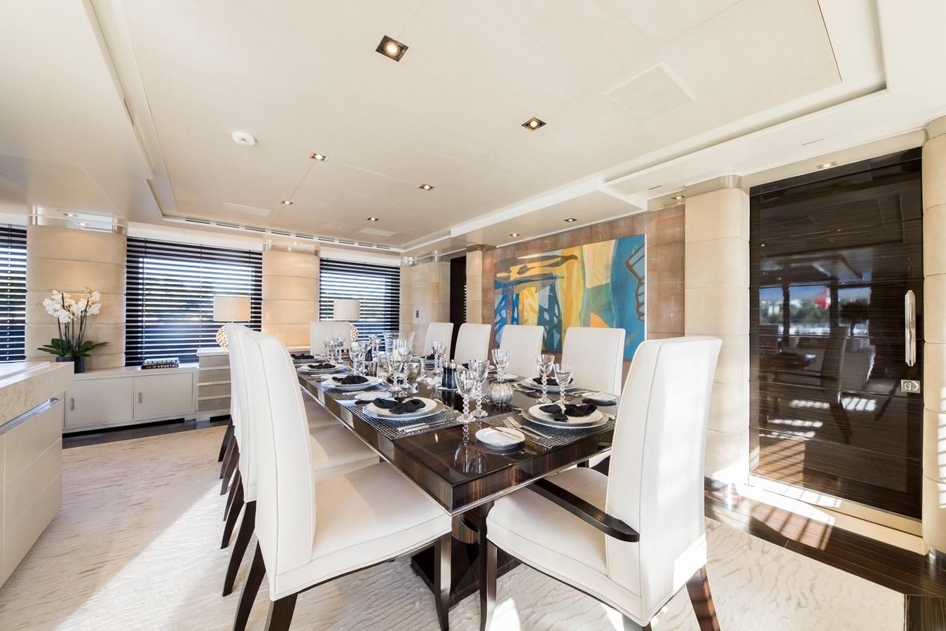 a large kitchen with a dining table aboard TIMBUKTU Yacht for Sale