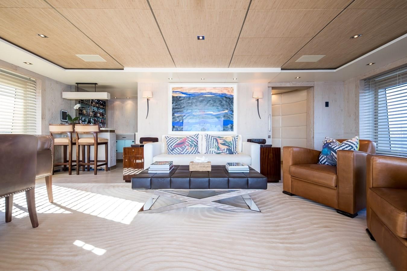 a large living room with a large screen aboard TIMBUKTU Yacht for Sale