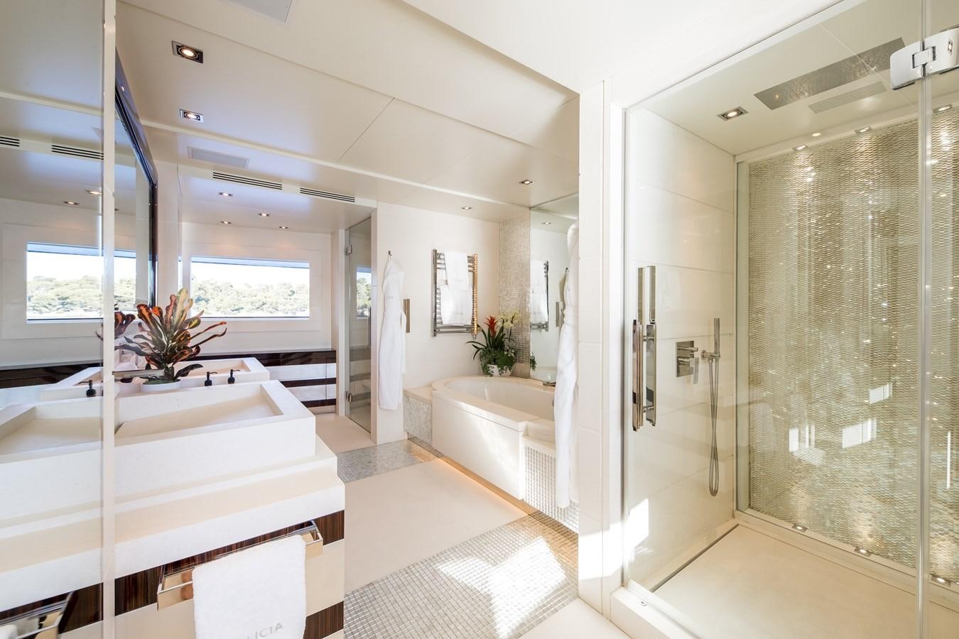 a bathroom with a tub and shower aboard TIMBUKTU Yacht for Sale