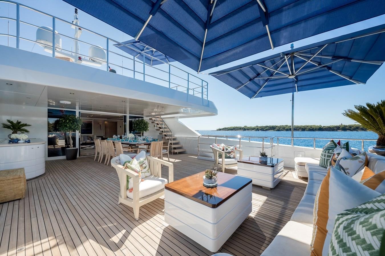 a patio with a table and chairs aboard TIMBUKTU Yacht for Sale