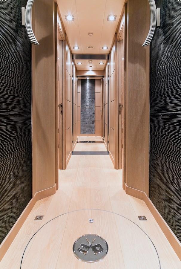 a hallway with a round window aboard AK ROYALTY Yacht for Sale