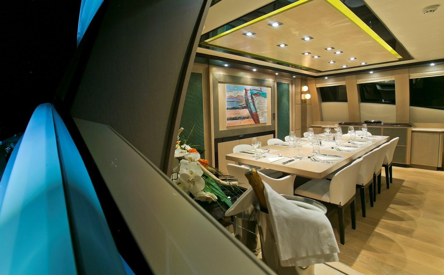 a dining room with a table and chairs aboard AK ROYALTY Yacht for Sale