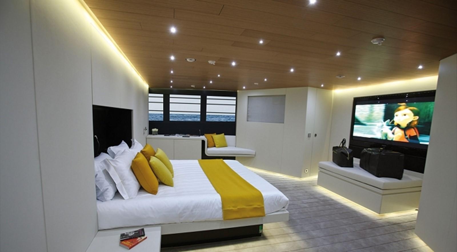 a room with a bed and a tv aboard OCEAN SAPPHIRE Yacht for Sale
