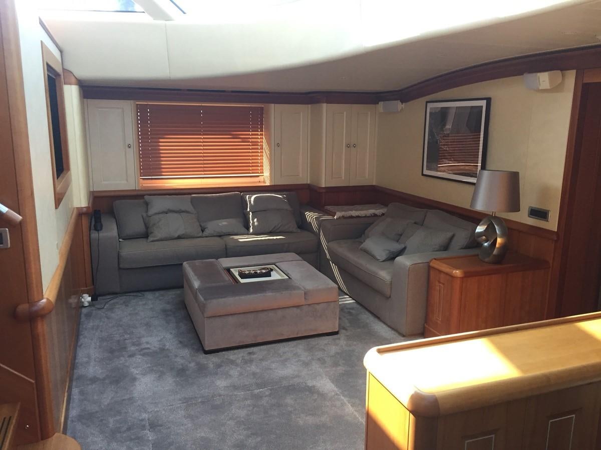 a living room with a couch and a coffee table aboard INMOCEAN Yacht for Sale