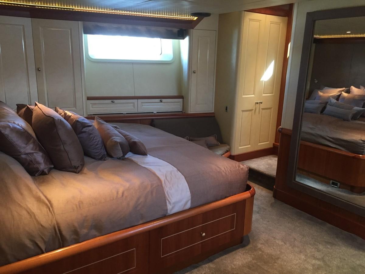 a bedroom with a bed and a window aboard INMOCEAN Yacht for Sale