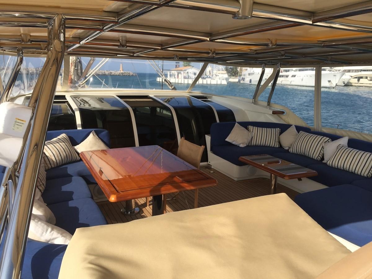 a boat with a table and chairs aboard INMOCEAN Yacht for Sale
