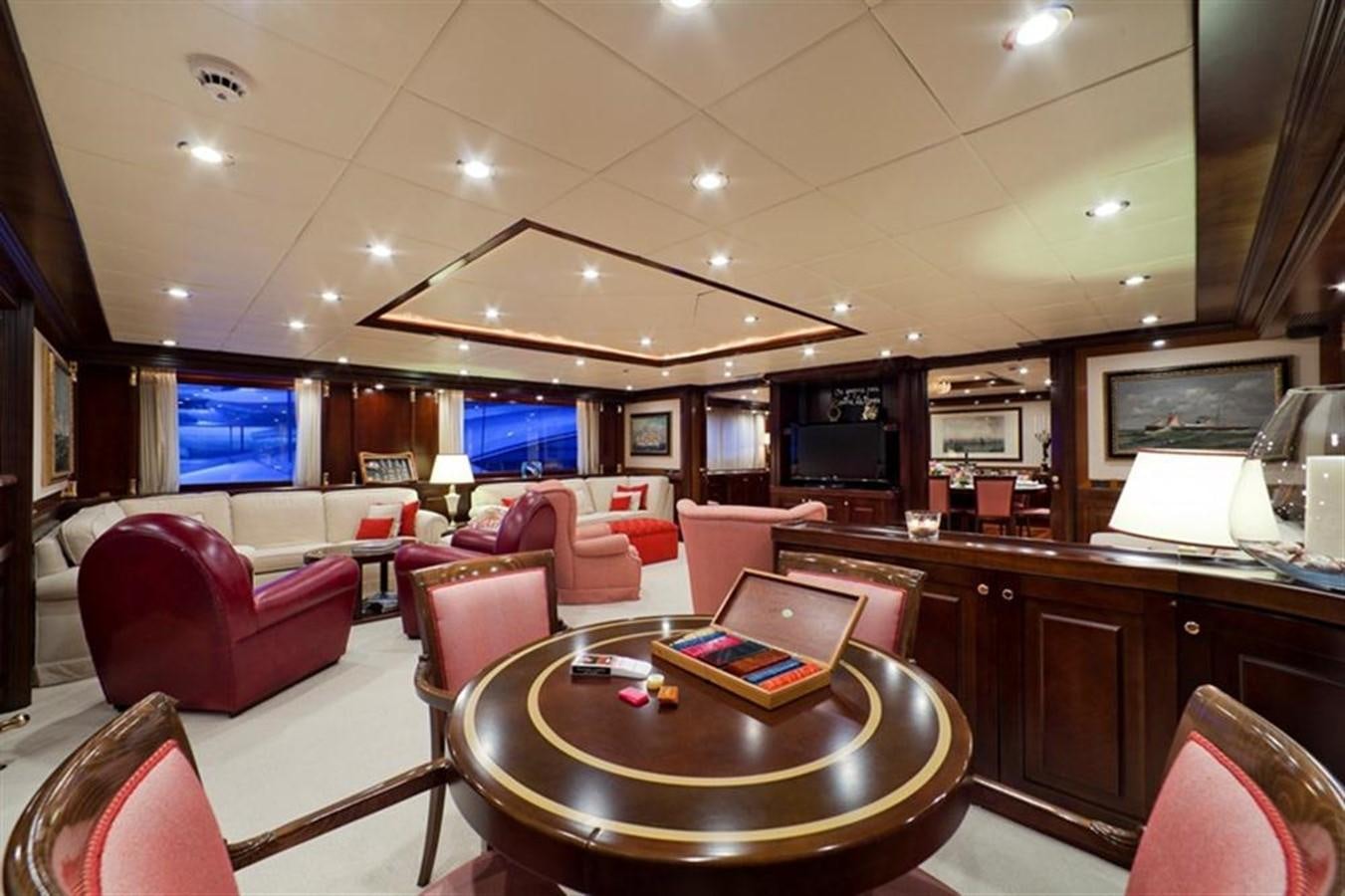 a large living room with a table and chairs aboard SOPHIE BLUE Yacht for Sale