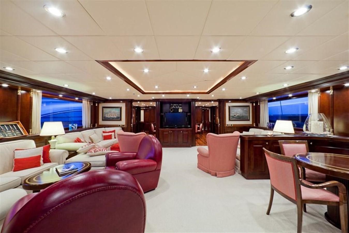 a room with a large table and chairs and a tv aboard SOPHIE BLUE Yacht for Sale