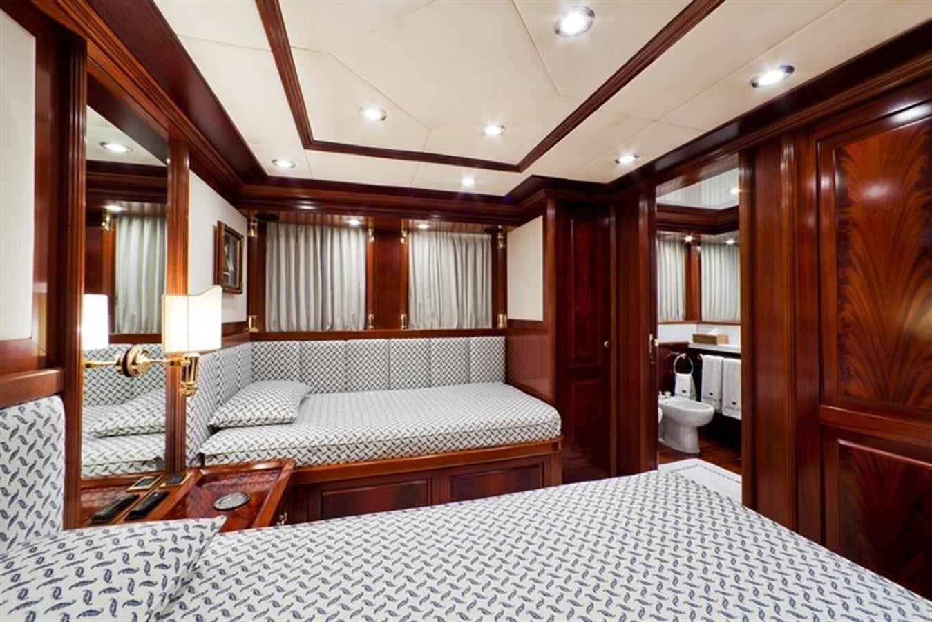 a bedroom with a bed and a mirror aboard SOPHIE BLUE Yacht for Sale