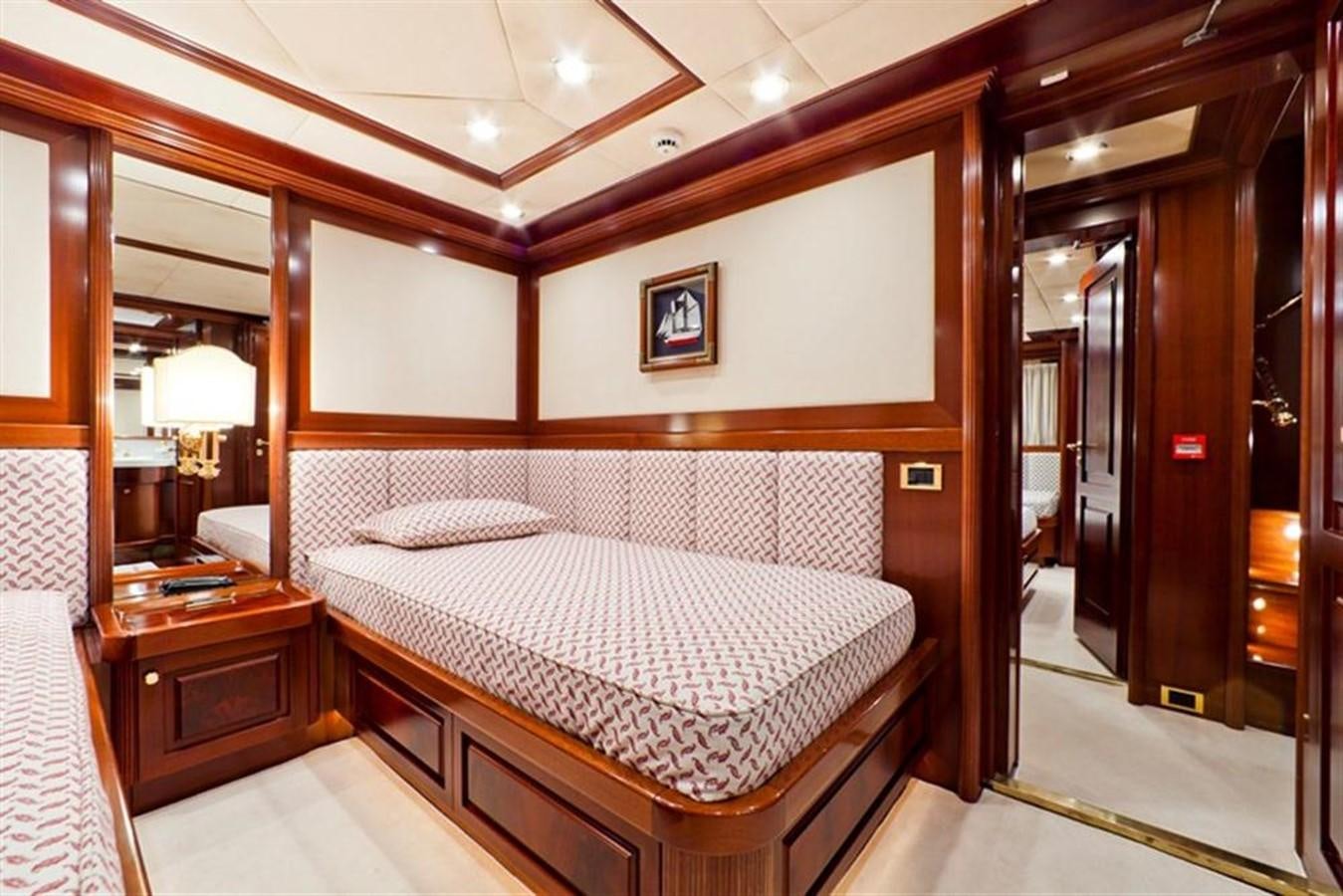 a bedroom with a bed and a mirror aboard SOPHIE BLUE Yacht for Sale
