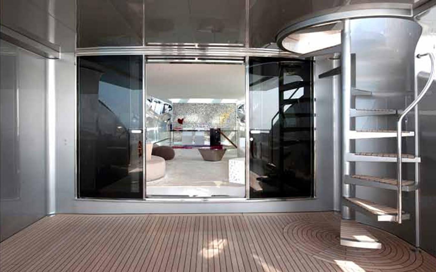 a room with a glass door and a wood floor aboard FLYING DAGGER Yacht for Sale