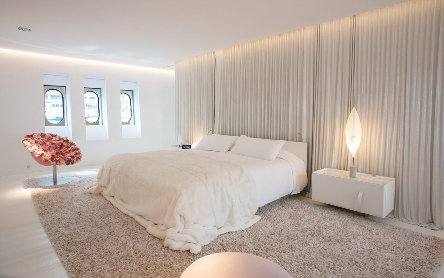 a bedroom with a bed and a table aboard FLYING DAGGER Yacht for Sale