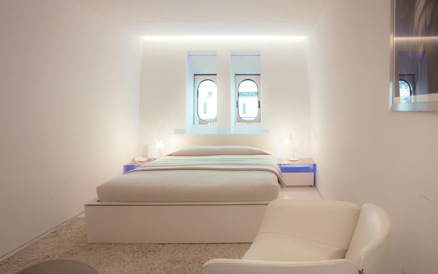 a room with a bed and a couch aboard FLYING DAGGER Yacht for Sale