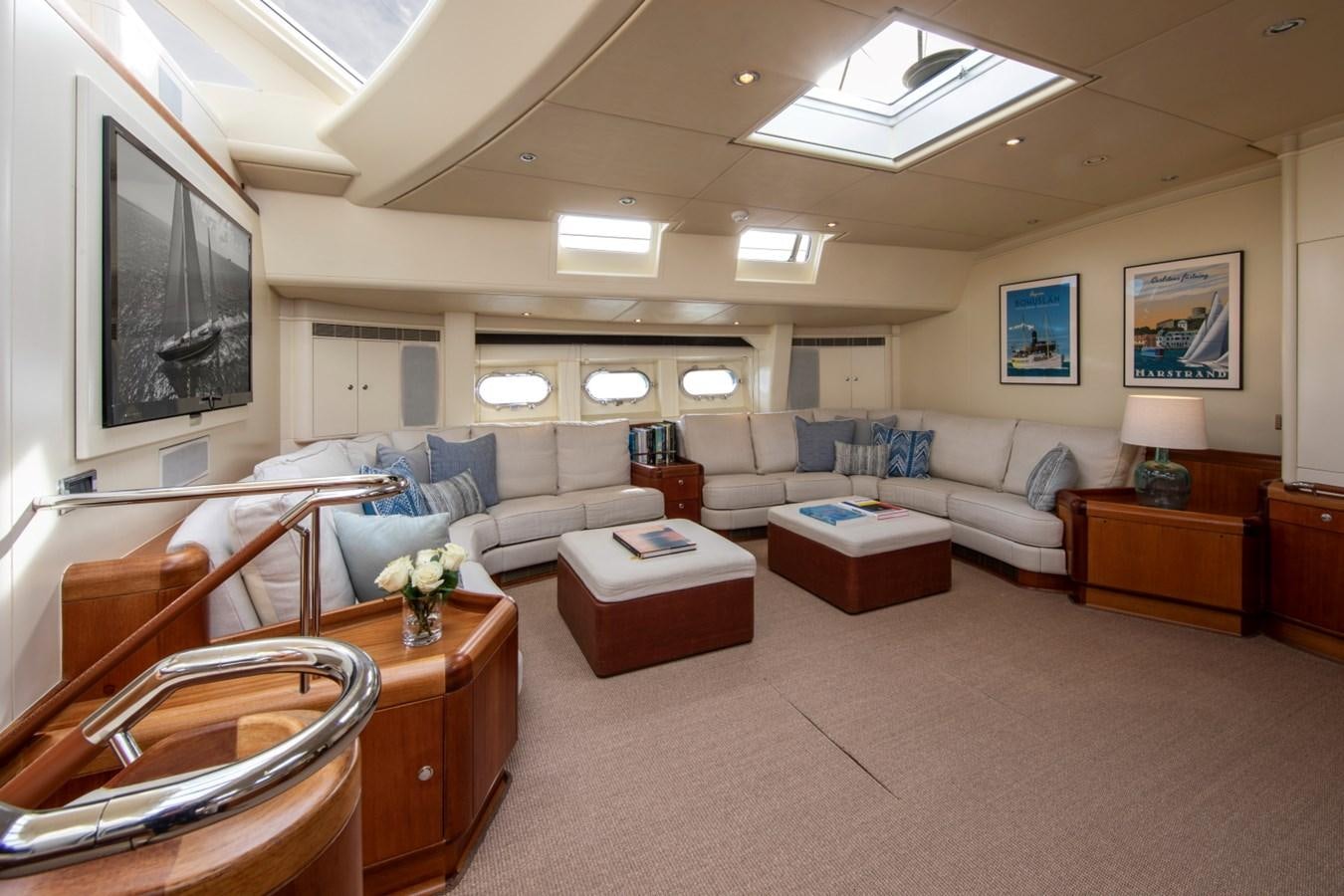 a living room with a large screen aboard SURAMA Yacht for Sale